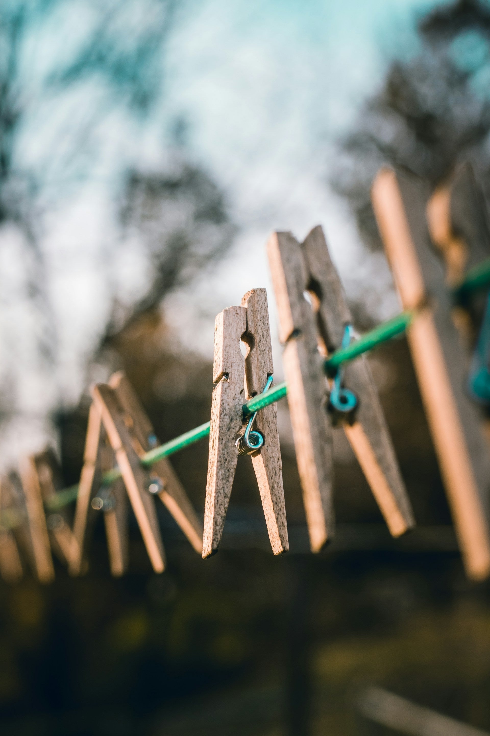 Clothespins hanging on a line outdoors, perfect for drying eco-friendly cloth diapers.